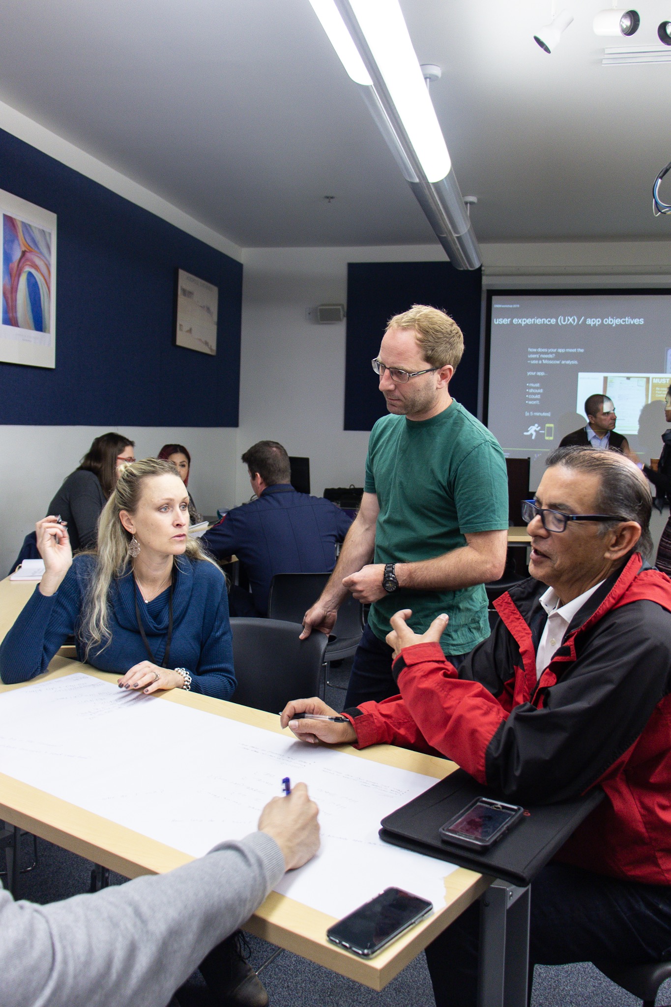 Klaus Kremer helping workshop participants develop a rapid prototype for an app.