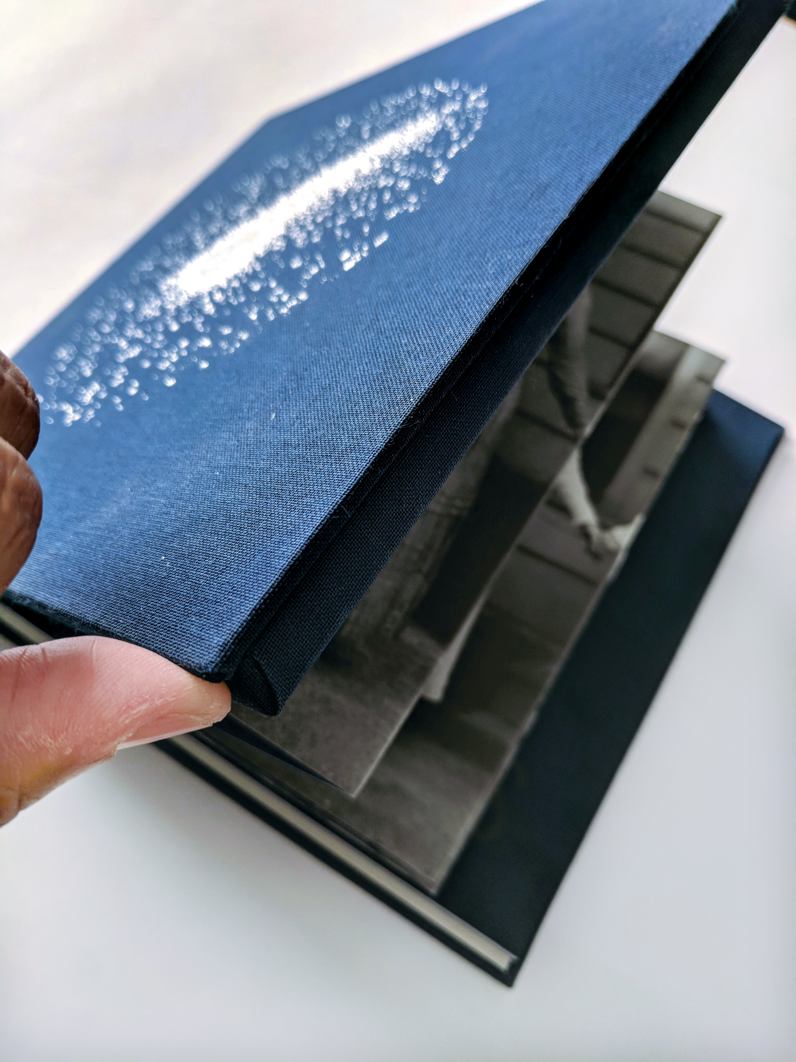 Close-up of hardcover case with navy blue canvas with foil ink.